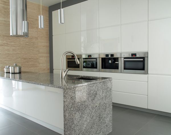 Modern minimalist white kitchen with grey granite countertop
